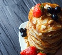 picture of pancakes with maple syrup and berries
